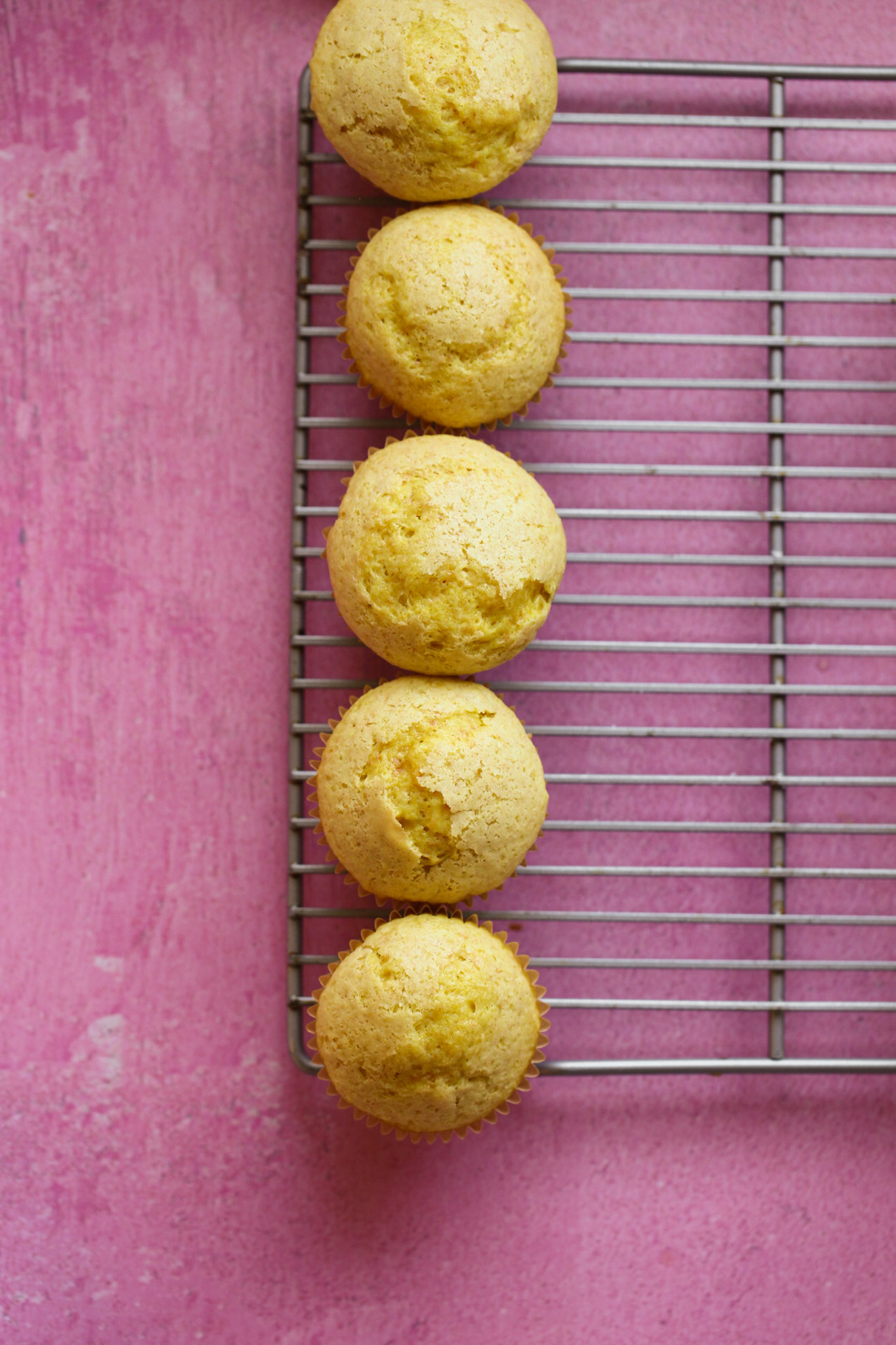 yellow cupcakes in a row, unfrosted