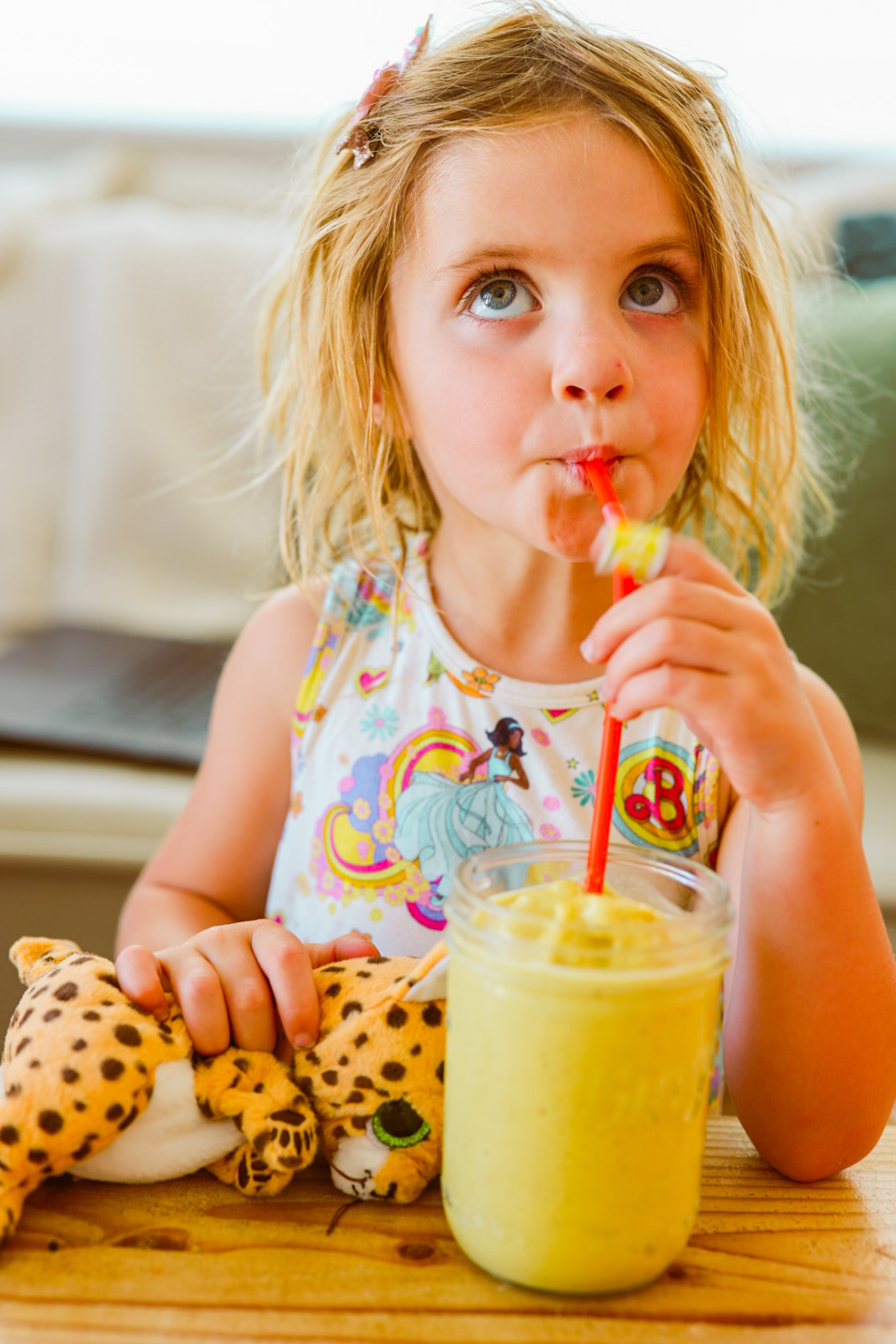 girl drinking yellow banana smoothie