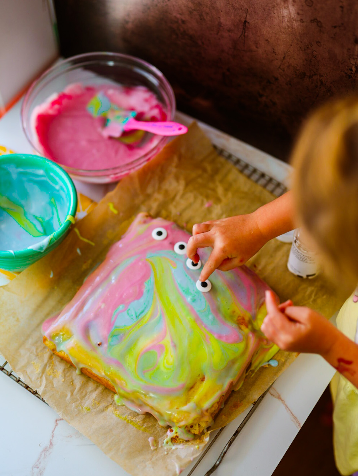 placing eyeballs on a monster cake