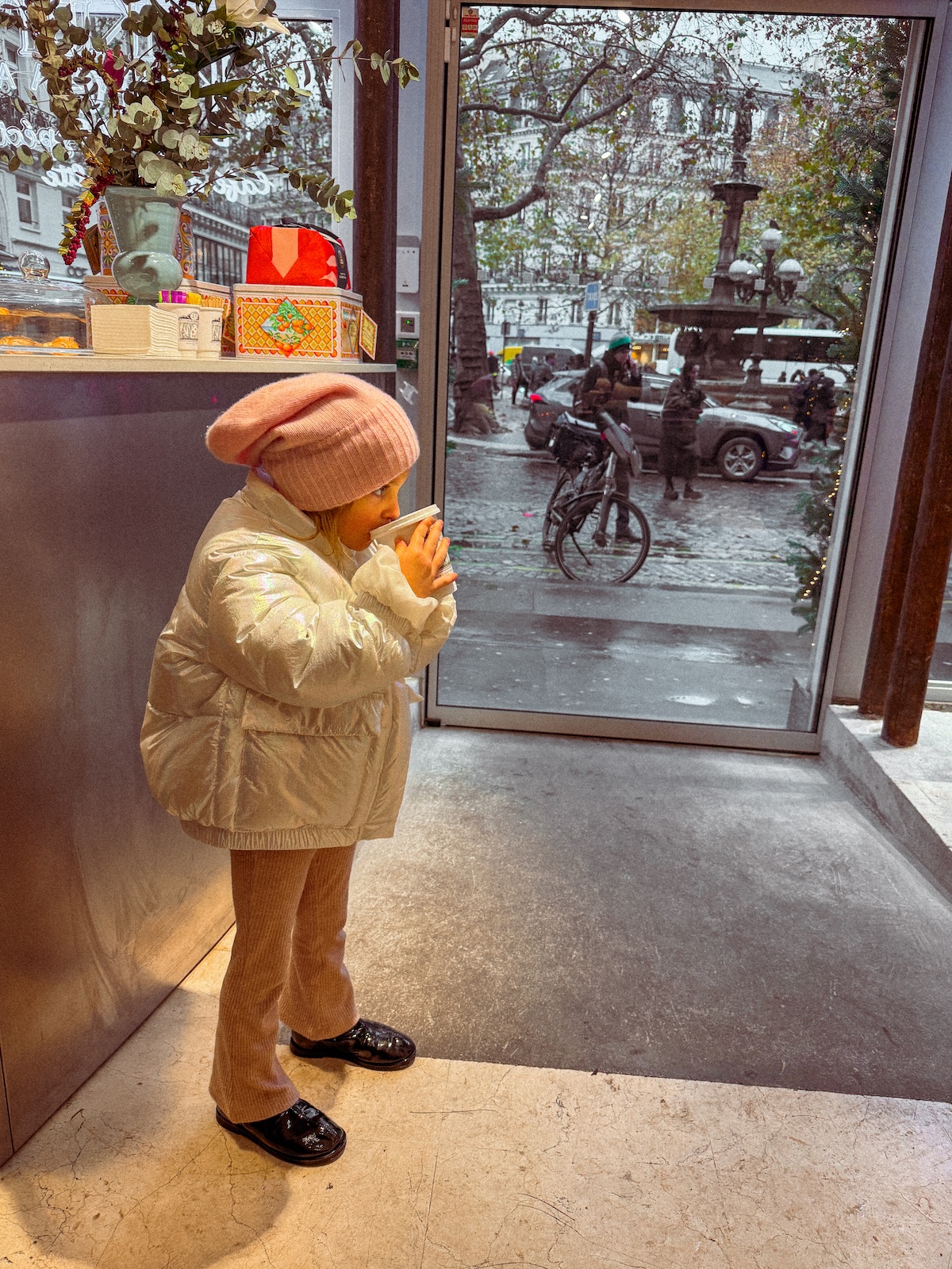 Paris in the rain kid sipping cocoa