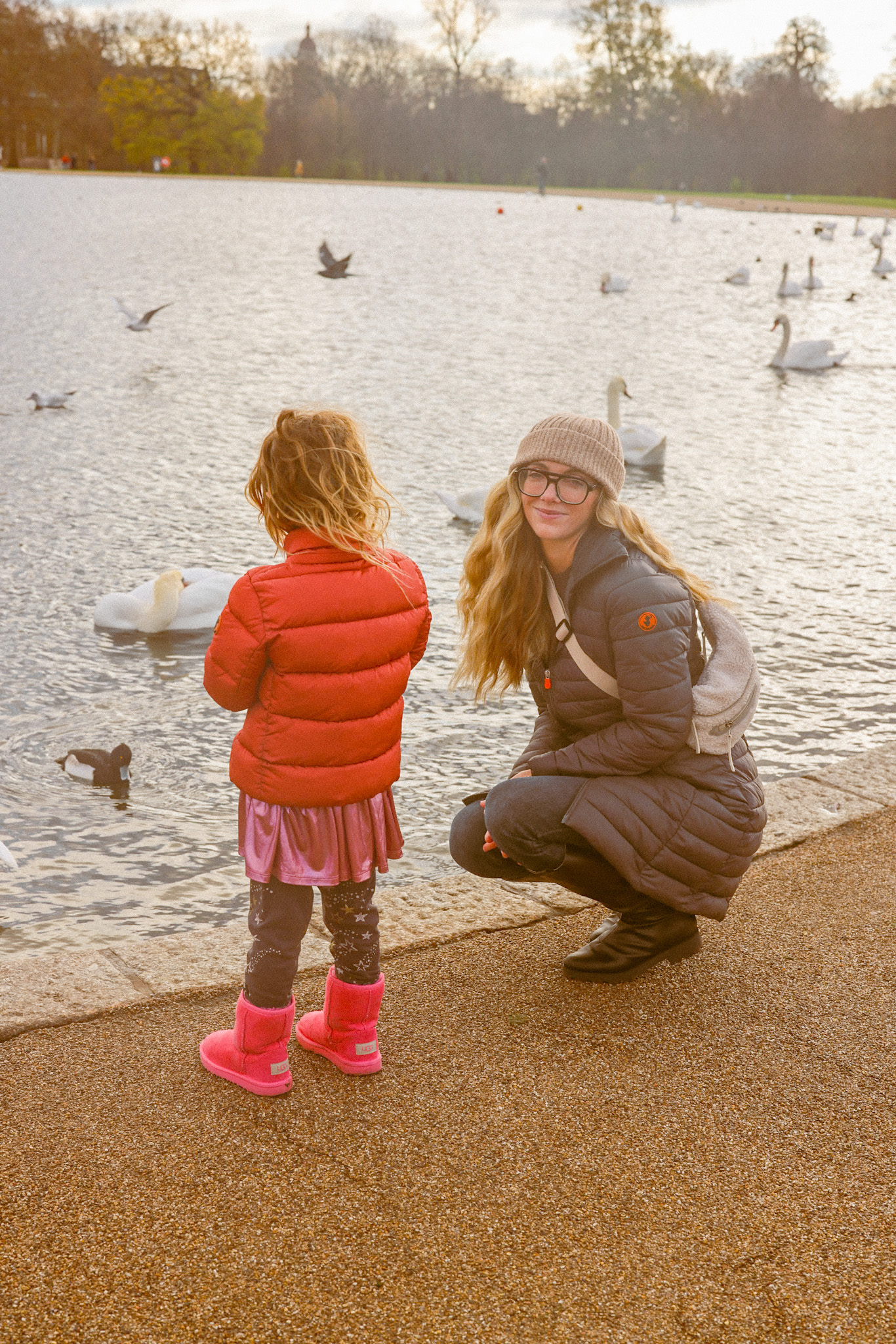 mom and kid round pond winter London